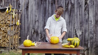 Boy draw lines and start cutting pumpkin 4K