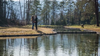 Couple sharing a tender moment at a scenic lake