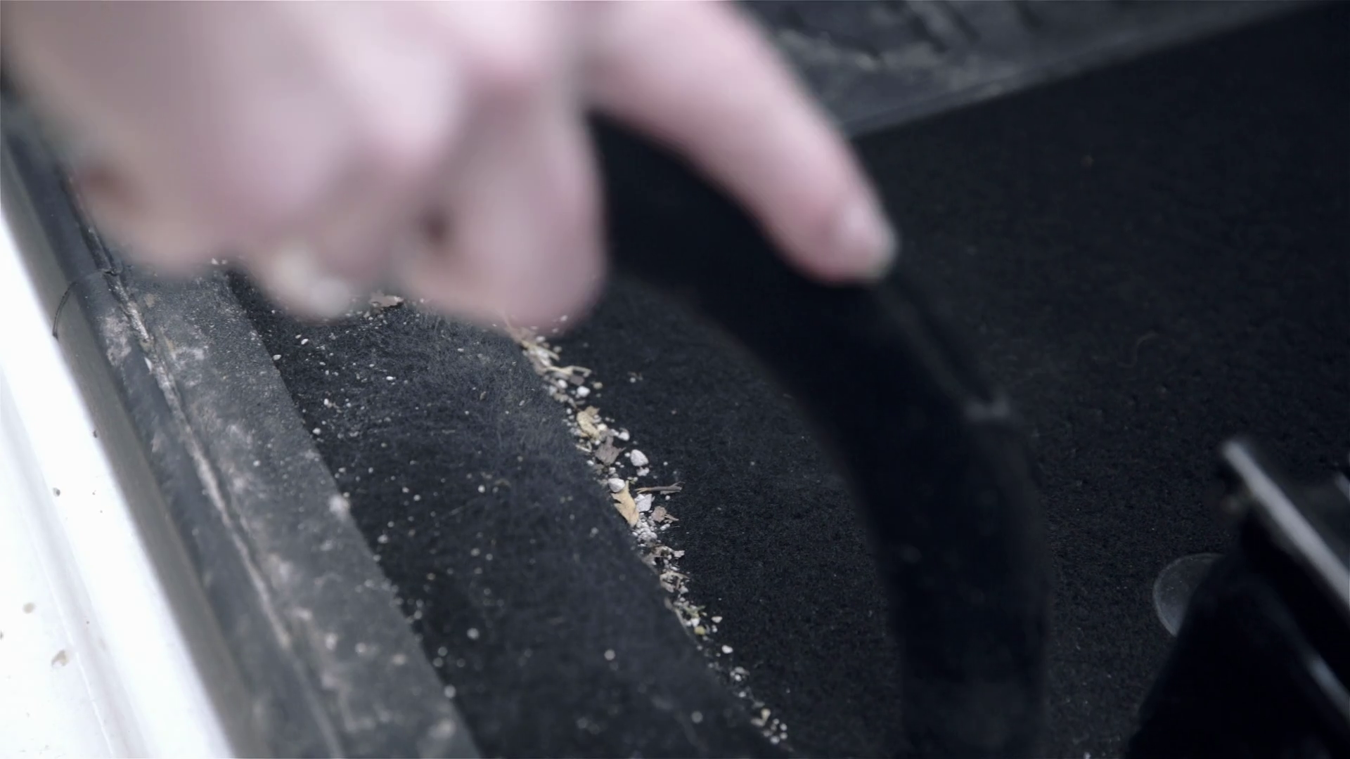 Vacuum cleaner removing dirt from car close up 4K. Person cleaning
