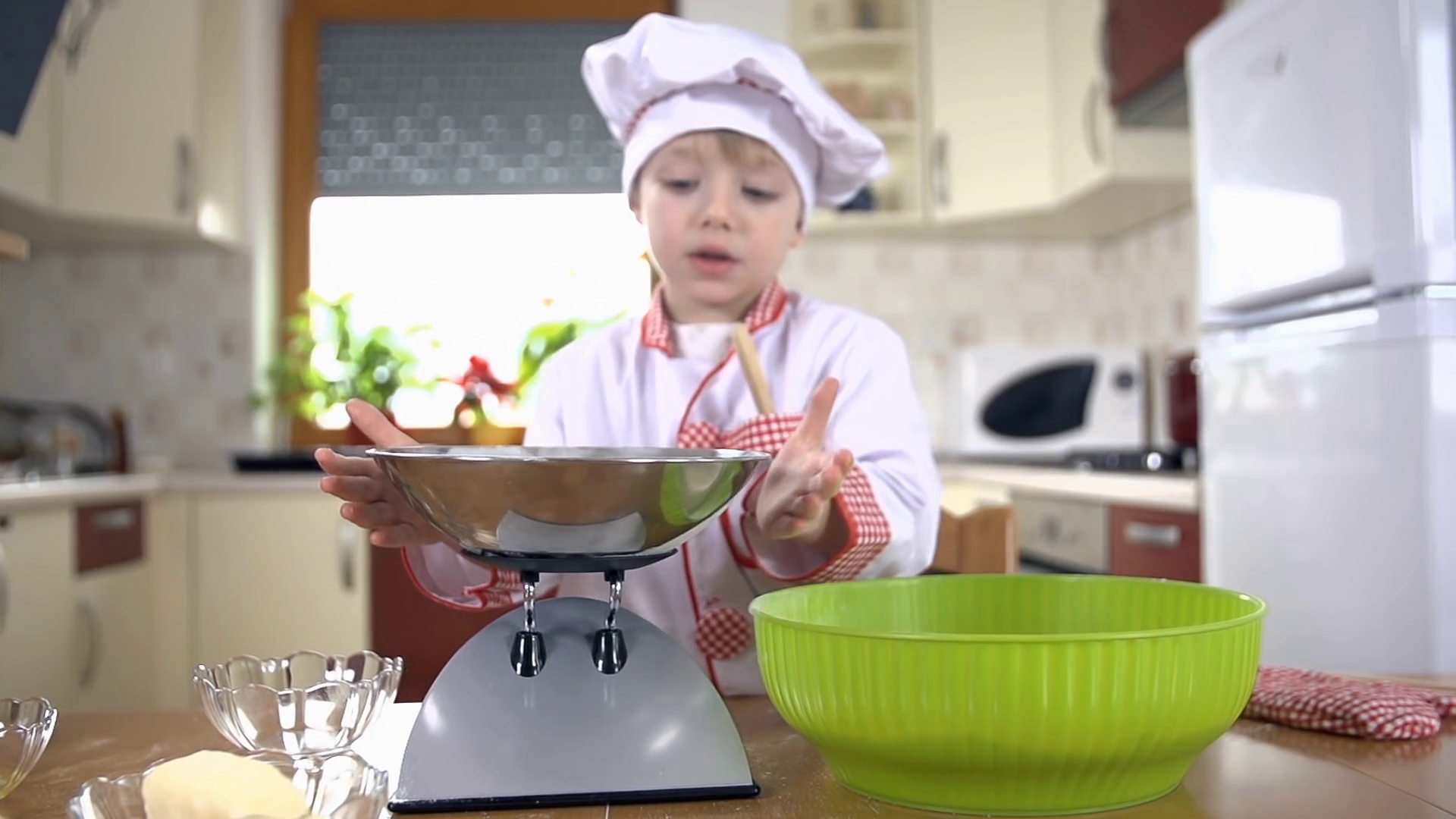 Young cook adds sugar to bigger bowl for mixing dough Stock Video