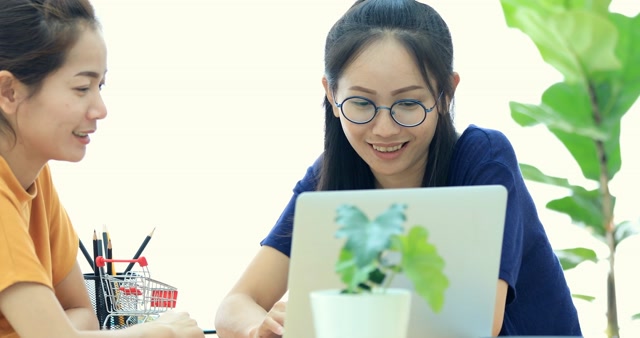 Videoblocks Two Beautiful Asian Business Women Are Working In A Light ...