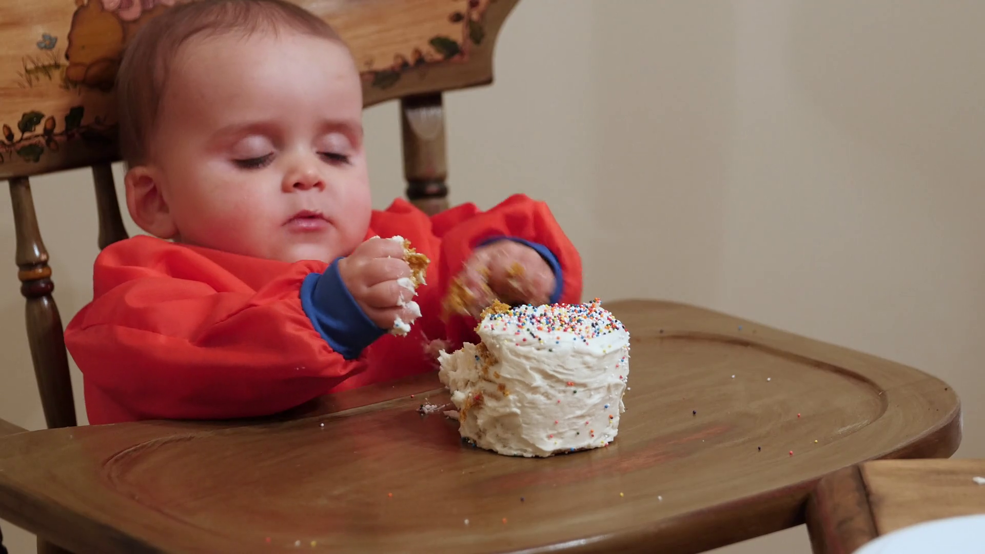 A messy baby boy eating his birthday cake with his family Stock Video