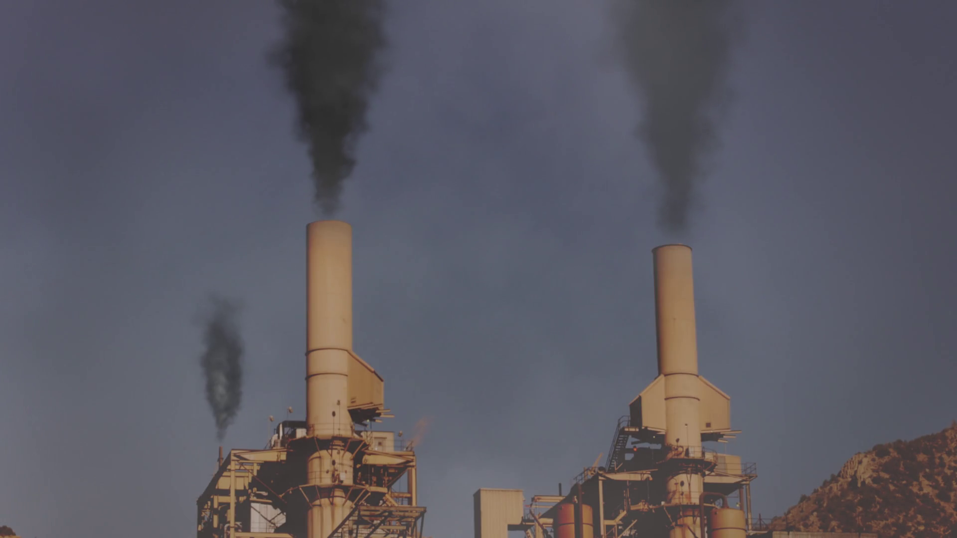 Smoke billowing out of smoke stacks at a coal plant Stock Video Footage