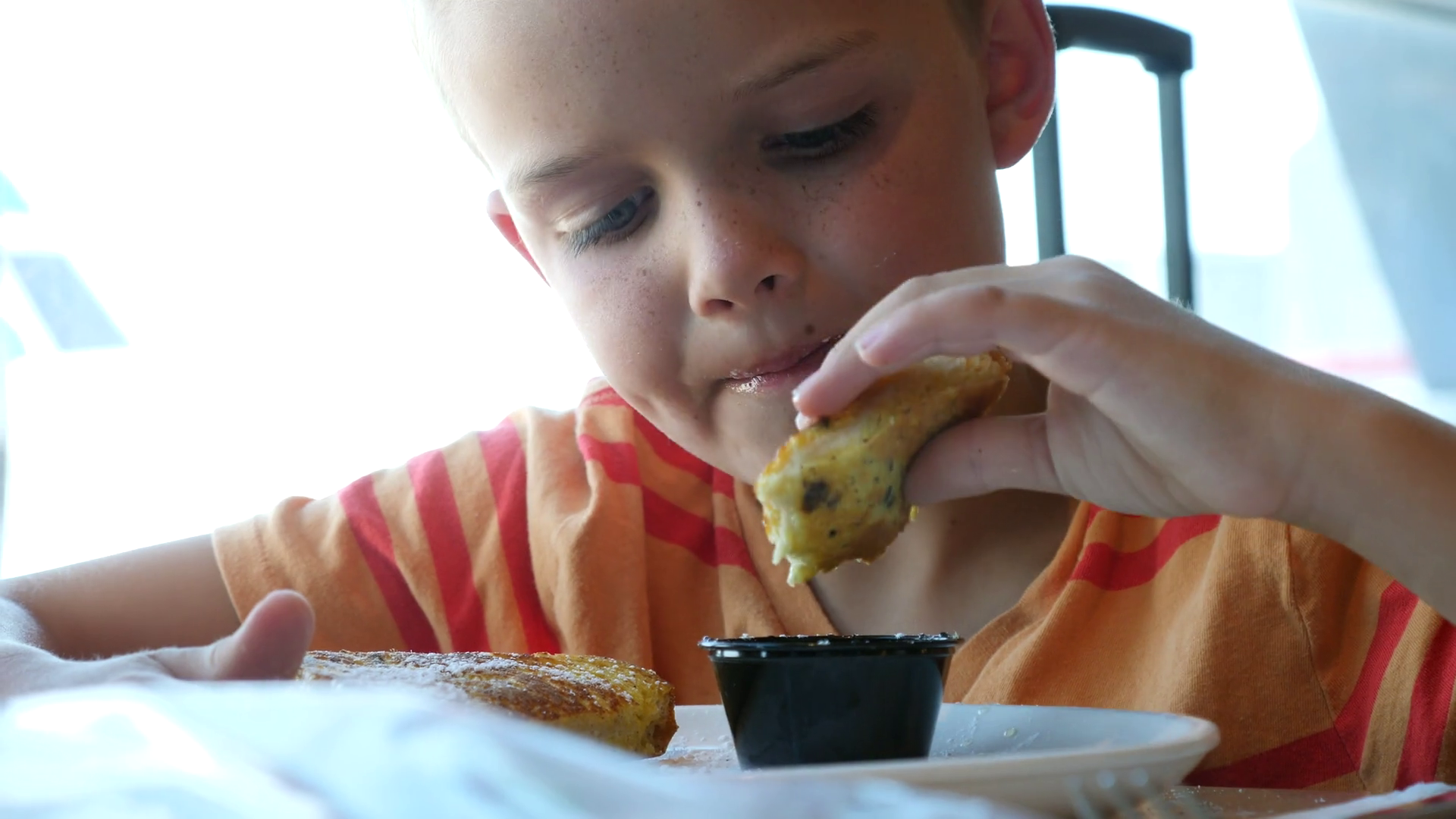 A Cute Boy Eating French Toast For Breakfast In A Restaraunt Stock Video Footage Storyblocks