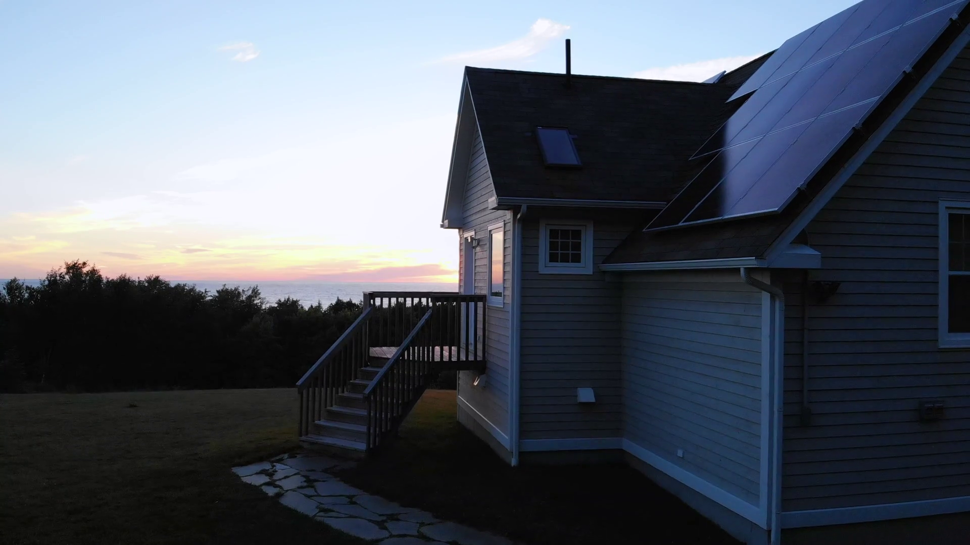 Aerial Of Coastal Home With Solar Panels At Sunset Stock Video Footage
