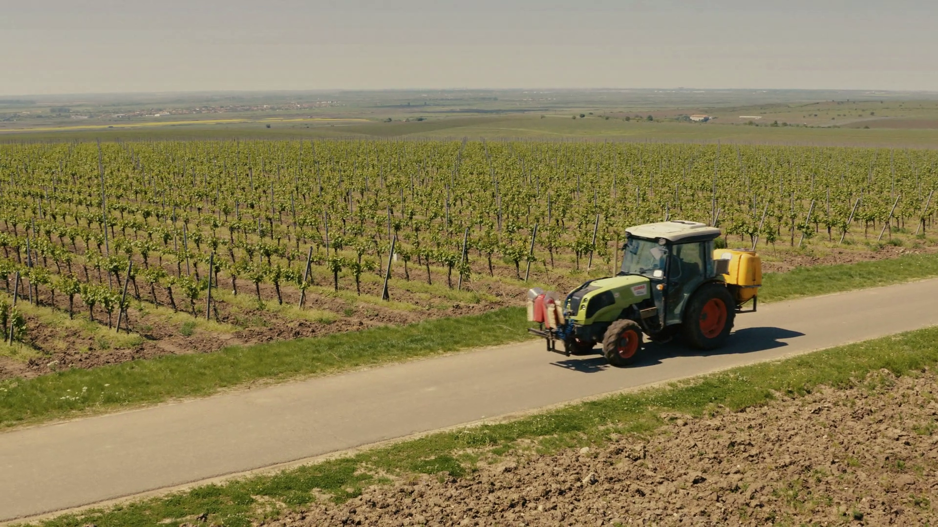Two tractors running on a wine route with tree ELS Stock Video