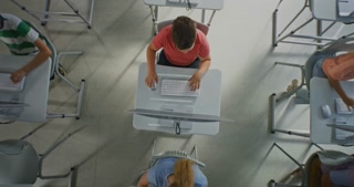 Group Schoolchildren at Computers in Modern Classroom. Class Kids Sit Separate Tables and Type on Desktop Computers. Students Learn Digital