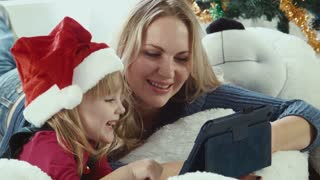Mom reads a Christmas story with touchpad