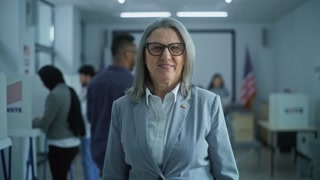 Portrait of mature woman, United States of America elections voter. Businesswoman stands in a modern polling station, poses and looks at