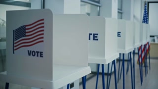 Voting booths with American flag logo in light polling station office. National Election Day in the United States of America. Political