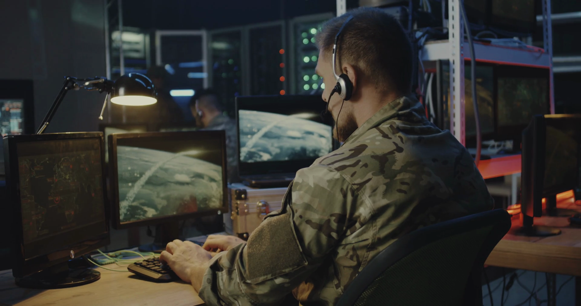 Medium close-up of soldiers controlling rocket launch on ...