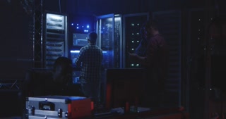 Young hackers collaborating in front of a world map display screen