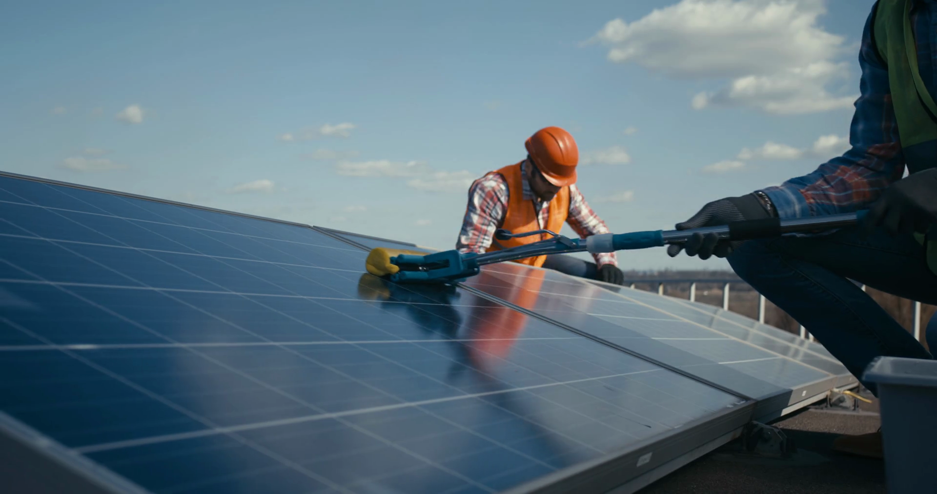 Medium shot of technicians cleaning and maintaining solar panels Stock