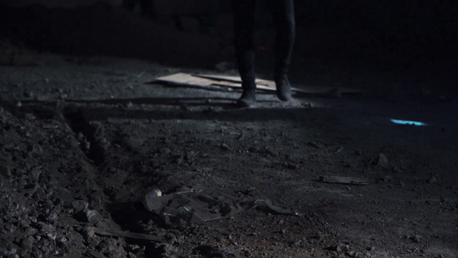 Police officer with flashlight finding evidence and looking at camera