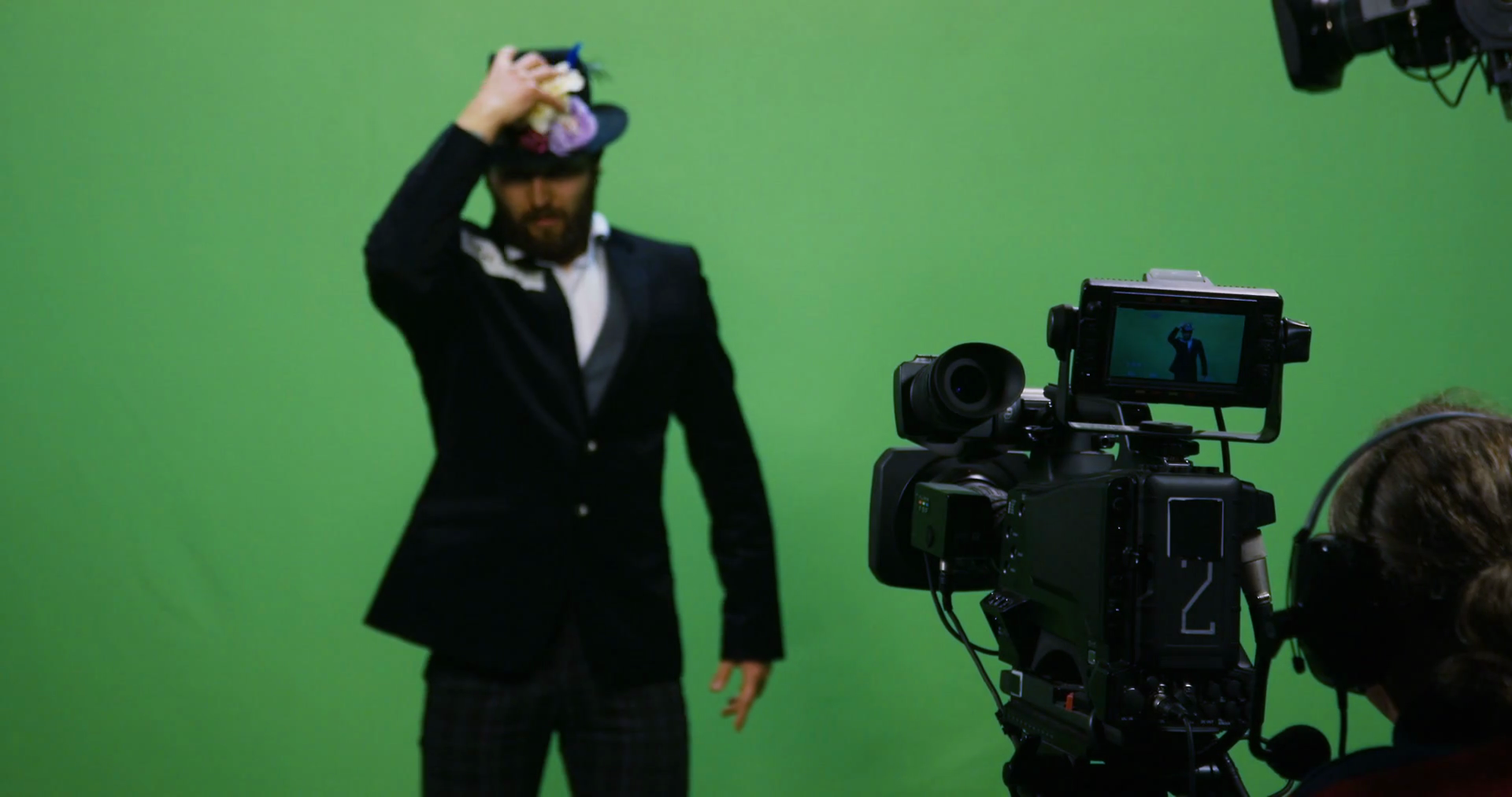 Slow motion shot of a cameraman recording an actor performing an