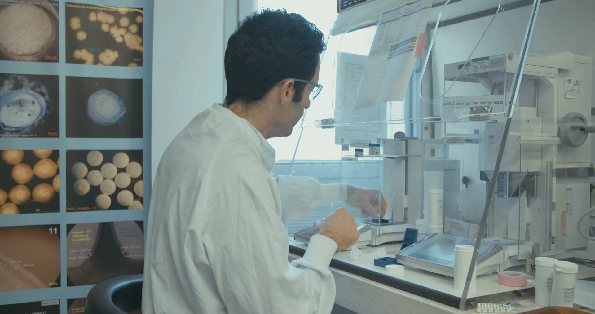 Lab technician working in a pharmaceutical laboratory weighing pills