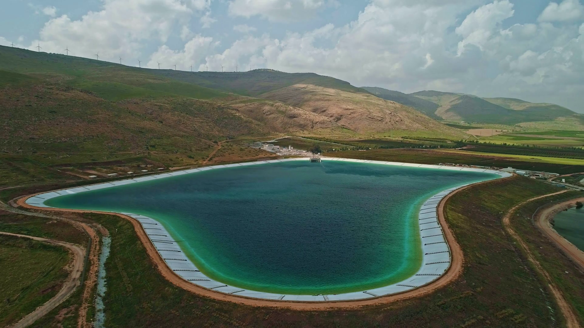 Aerial footage of a large water reservoir in north Israel Stock Video
