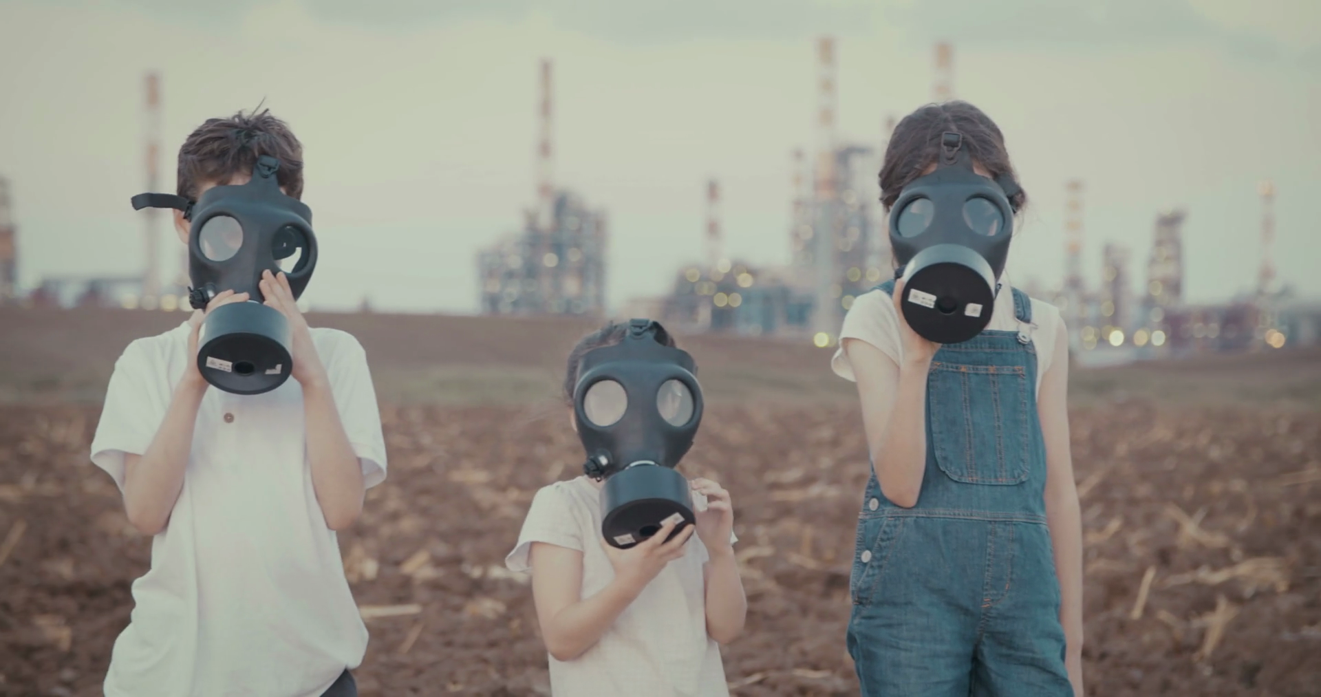 Save the plant. Kids wearing gas masks near an oil refinery Stock Video Footage Storyblocks