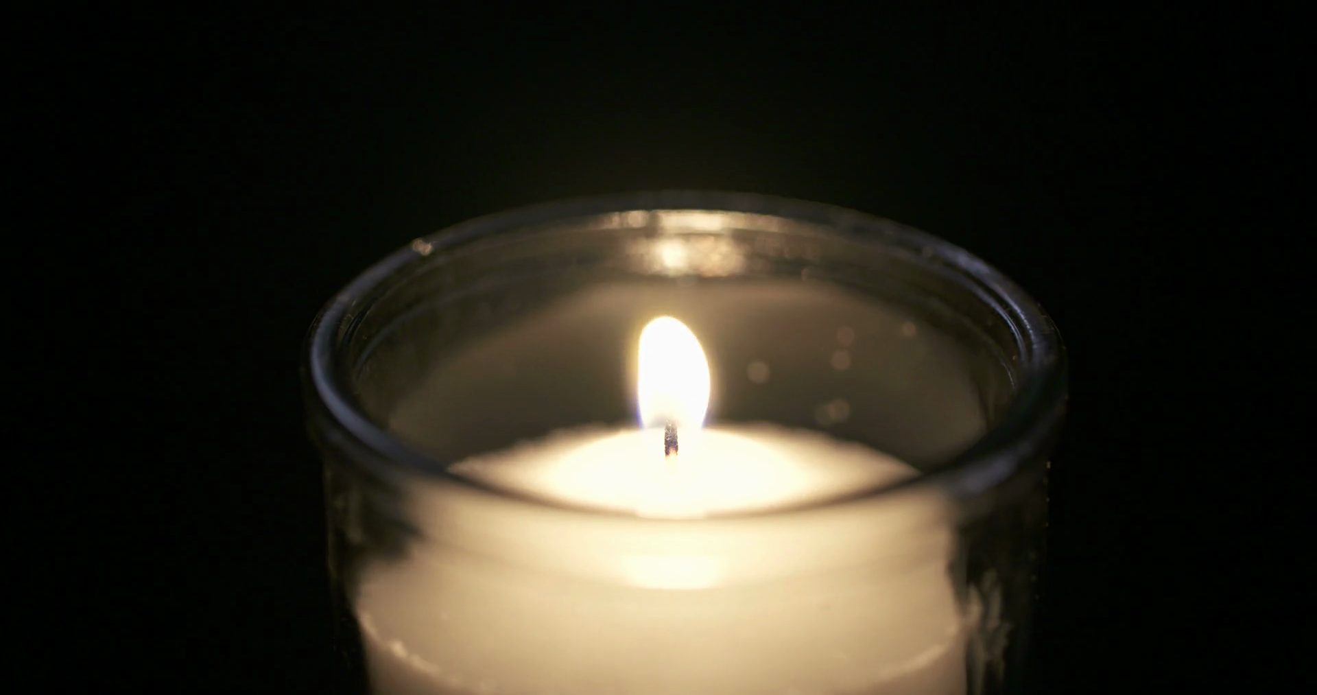 White Candle Burning On Dark Background Stock Footage SBV314007050