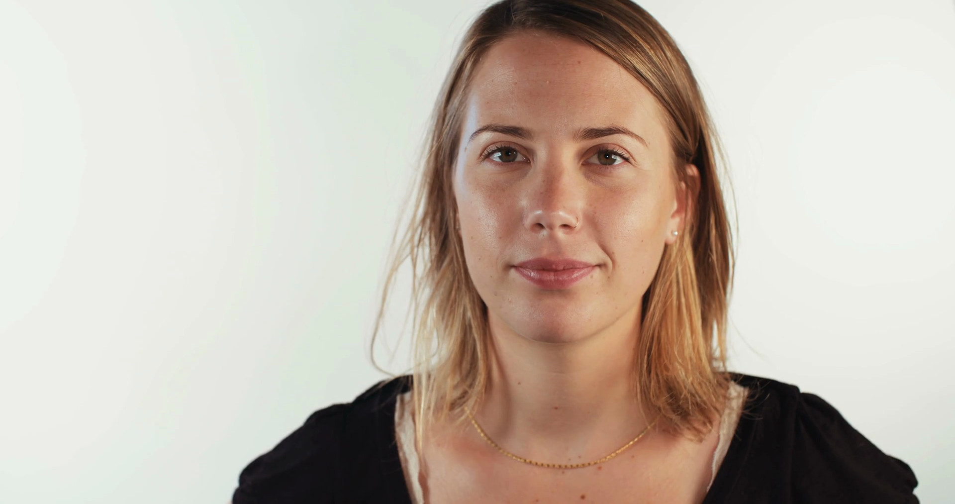 young blonde woman raising her eyebrow on white background Stock Video