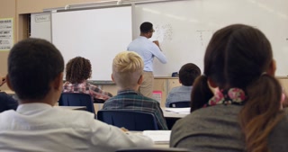 5th grade math class watches teacher, back view, shot on R3D