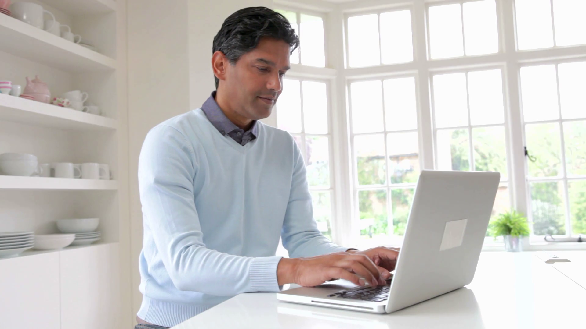 Indian Man Using Laptop Computer In Kitchen At Home Stock Video Footage ...