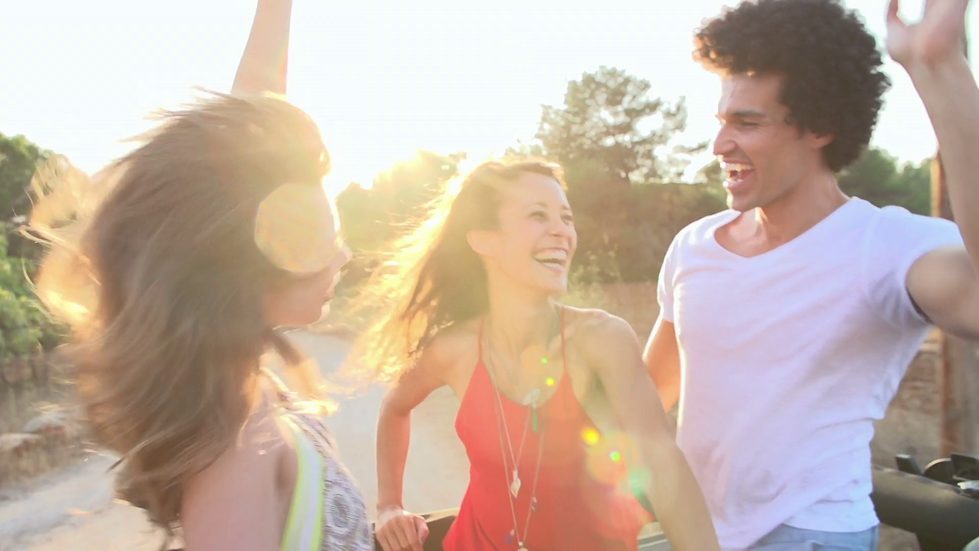 Slow Motion Shot Of Friends Dancing In Back Of Open Top Car Stock Video