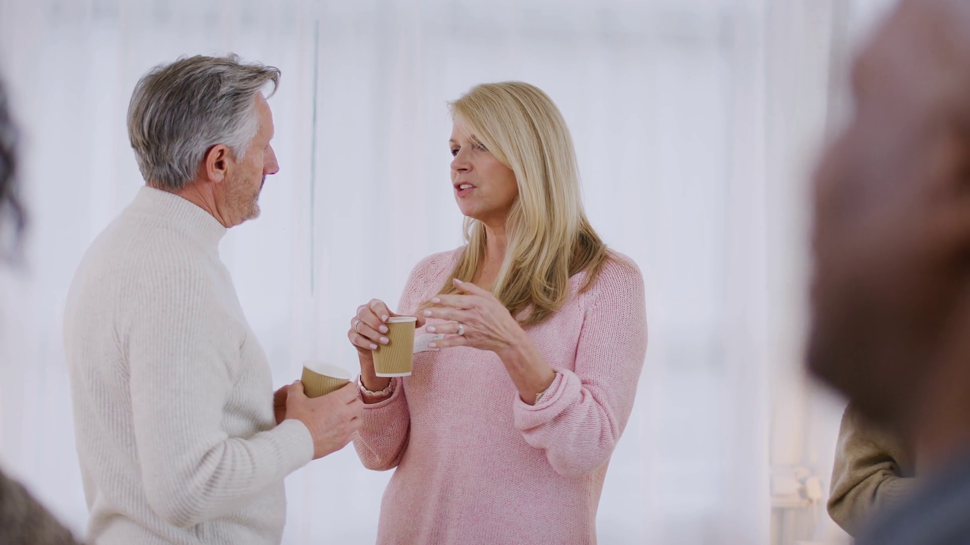 Group of people drinking coffee and chatting at informal meeting to