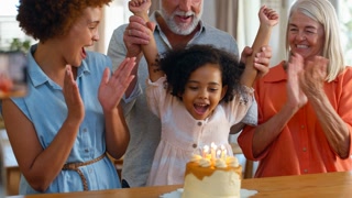Dad Takes Photo As Multi-Generation Family Celebrate Granddaughter's Birthday At Home With Cake