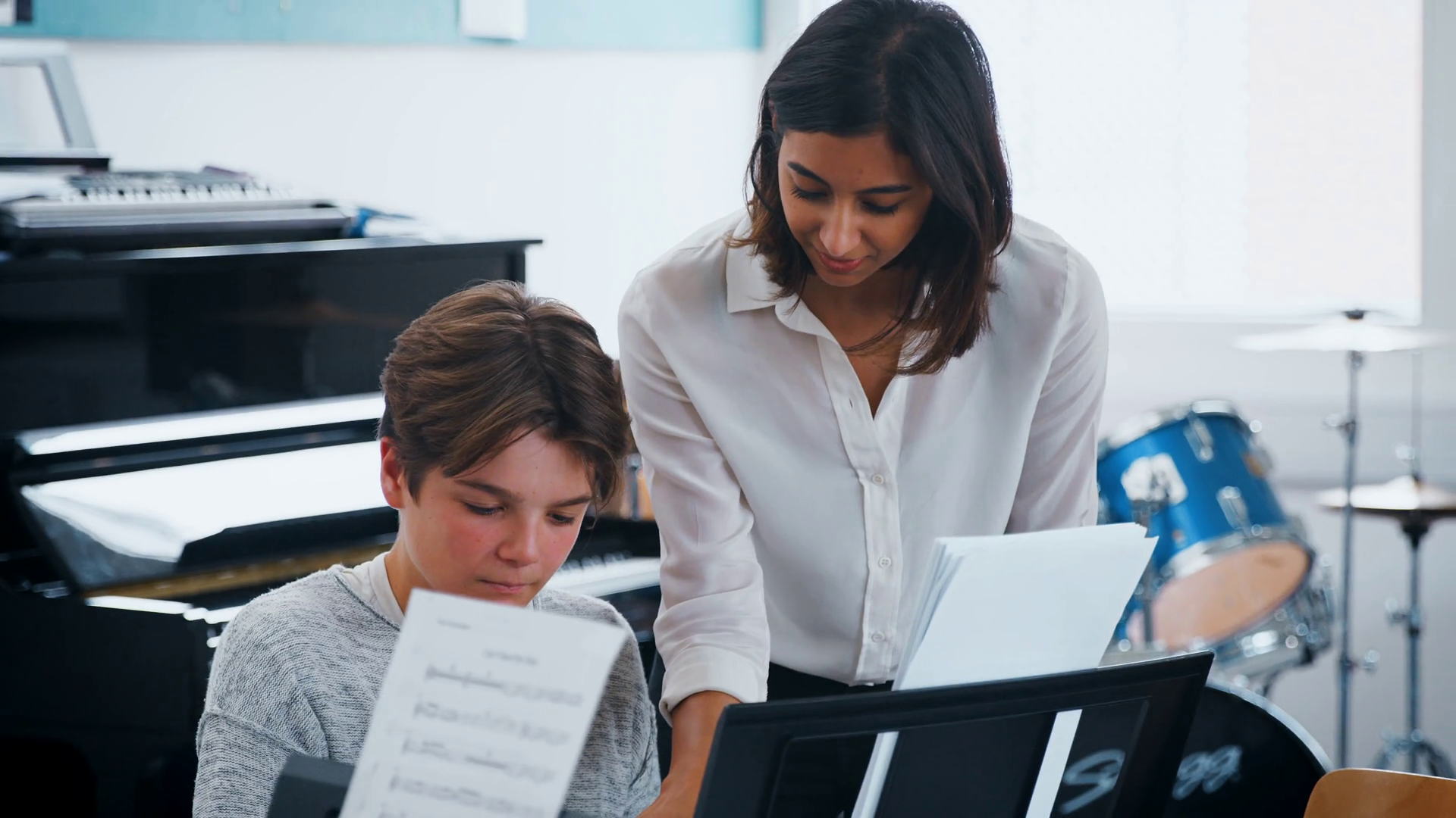 Male Pupil With Teacher Playing Piano In Music Lesson Stock Video