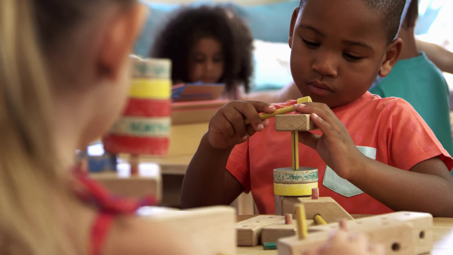 Montessori School Pupils Work At Desk With Wooden Building Set Stock