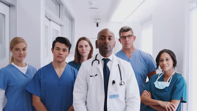 Portrait Of Multi Cultural Medical Team Standing In Hospital Corridor ...