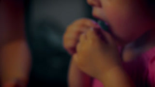 A cute little girl eats the decorations from her birthday cake