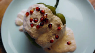 Pomegranate seeds are sprinkled over Chiles Poblanos, top view