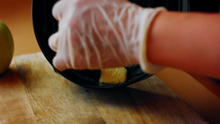 Coating the baking pan with a piece of butter