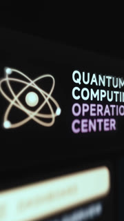 Quantum Computing Operations Center Header Beside A Glowing Atom Emblem