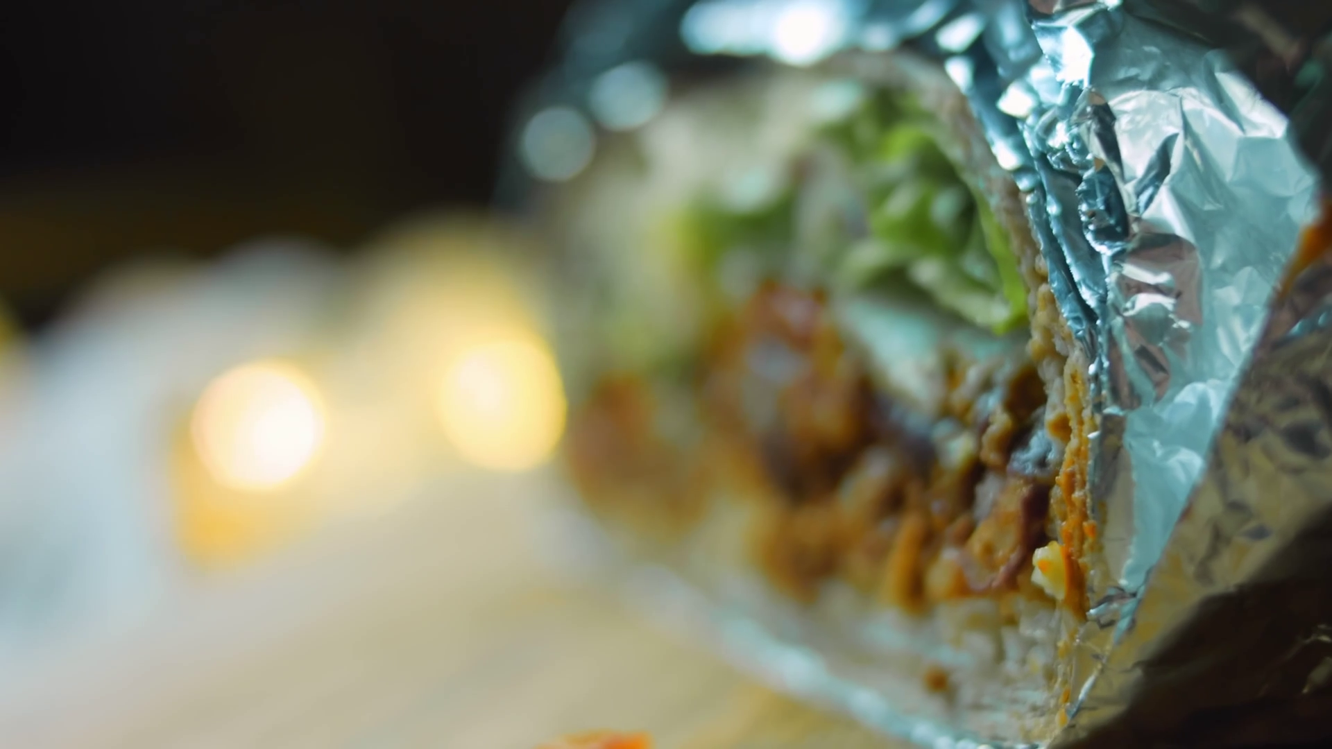 Very large burrito with avocado and chorizo meat. Filming in a romantic