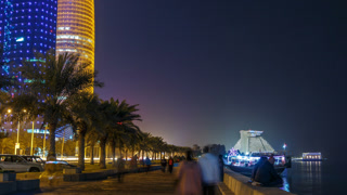 The skyline of Doha by night with starry sky seen from Corniche timelapse, Qatar