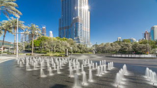 Fountains near main entrance to the tallest skyscraper timelapse hyperlapse, Dubai