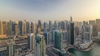 Aerial top view of Dubai Marina morning timelapse. Modern towers and traffic on the road