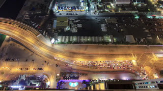 City view of Dubai road with traffic from skyscraper at night timelapse