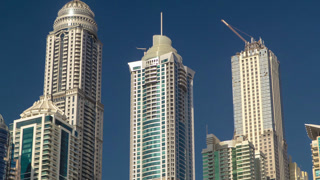 Dubai Marina with tallest skyscrapers and boats timelapse hyperlapse