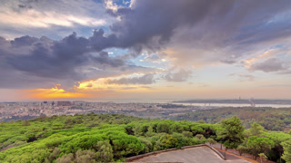 Panoramic sunrise view over Lisbon and Almada from a viewpoint in Monsanto morning timelapse.