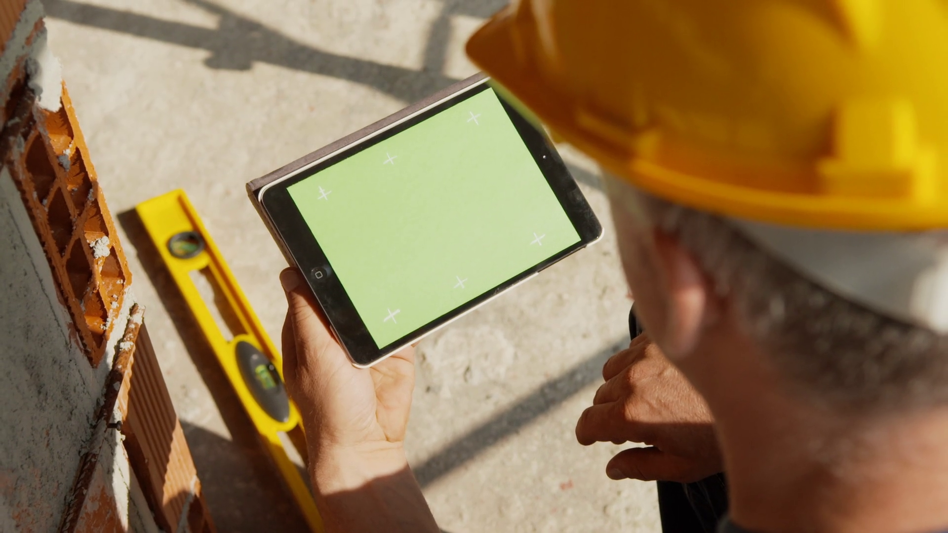 Manual worker, engineer, architect at work in construction site using