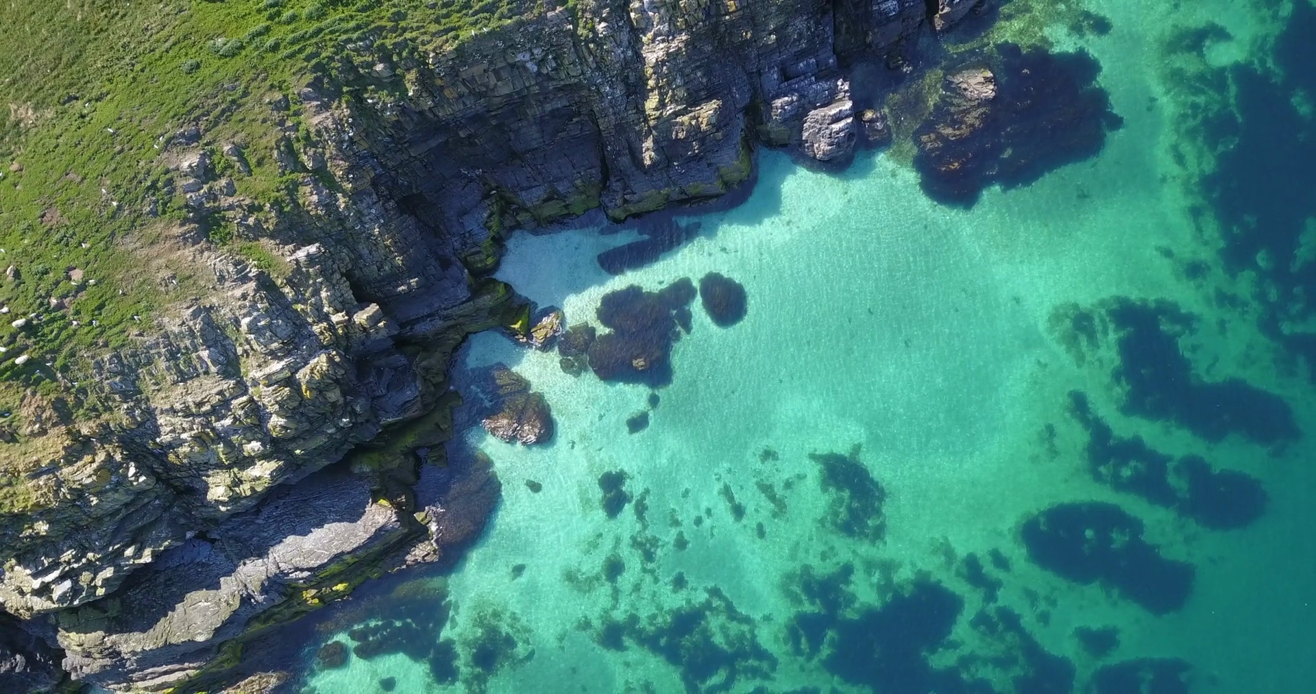 Drone flying in the sky over the coastline near Peel on the Isle of Man