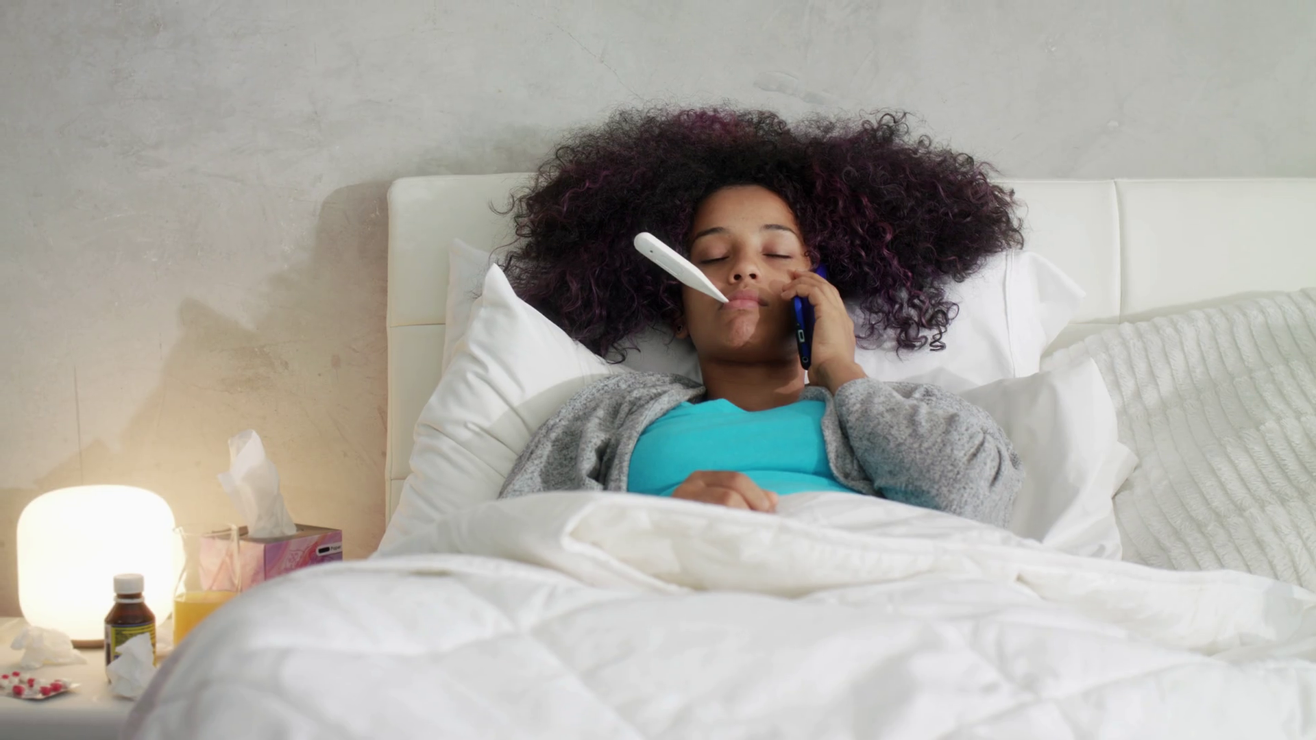 Woman With Fever Using Thermometer And Calling Doctor By Phone Stock