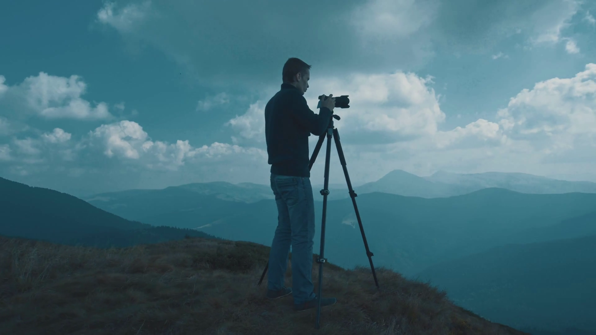 The man with a camera shots mountains Stock Video Footage 0018 SBV