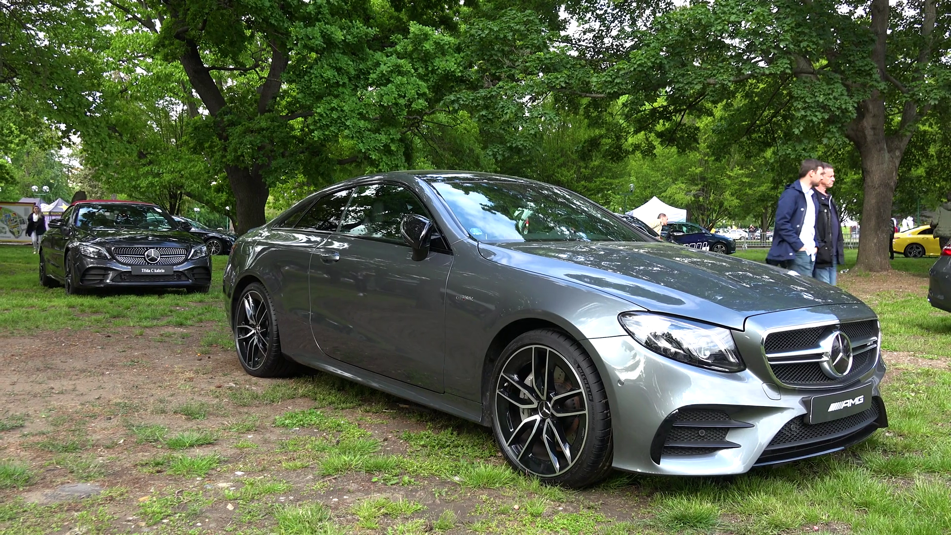 A Close Up Side View Of Mercedes Car At A Car Exhibition Outside In A Field People Walk In The Background A Man Goes Inside Another Car Stock Video Footage Storyblocks