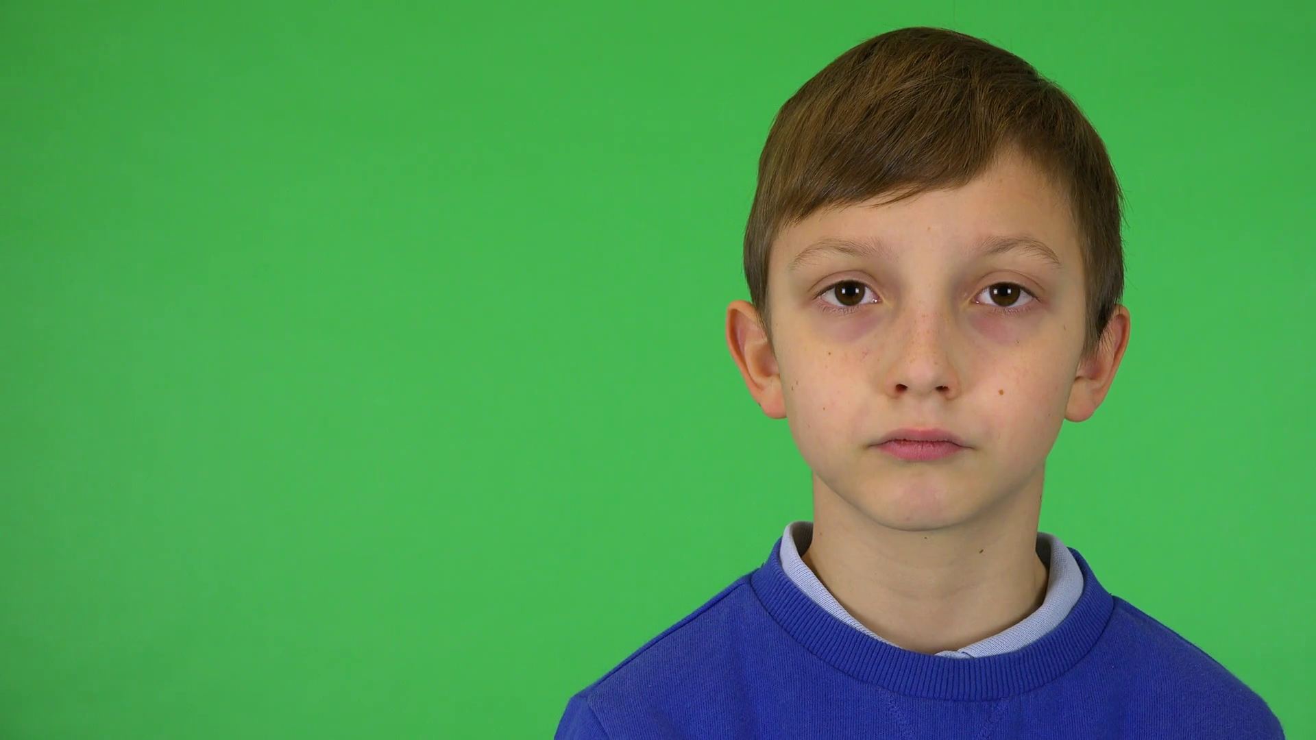 A Young Cute Boy Looks Seriously At Camera Stock Footage SBV