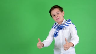 Young boy shows thumbs up - green screen - studio